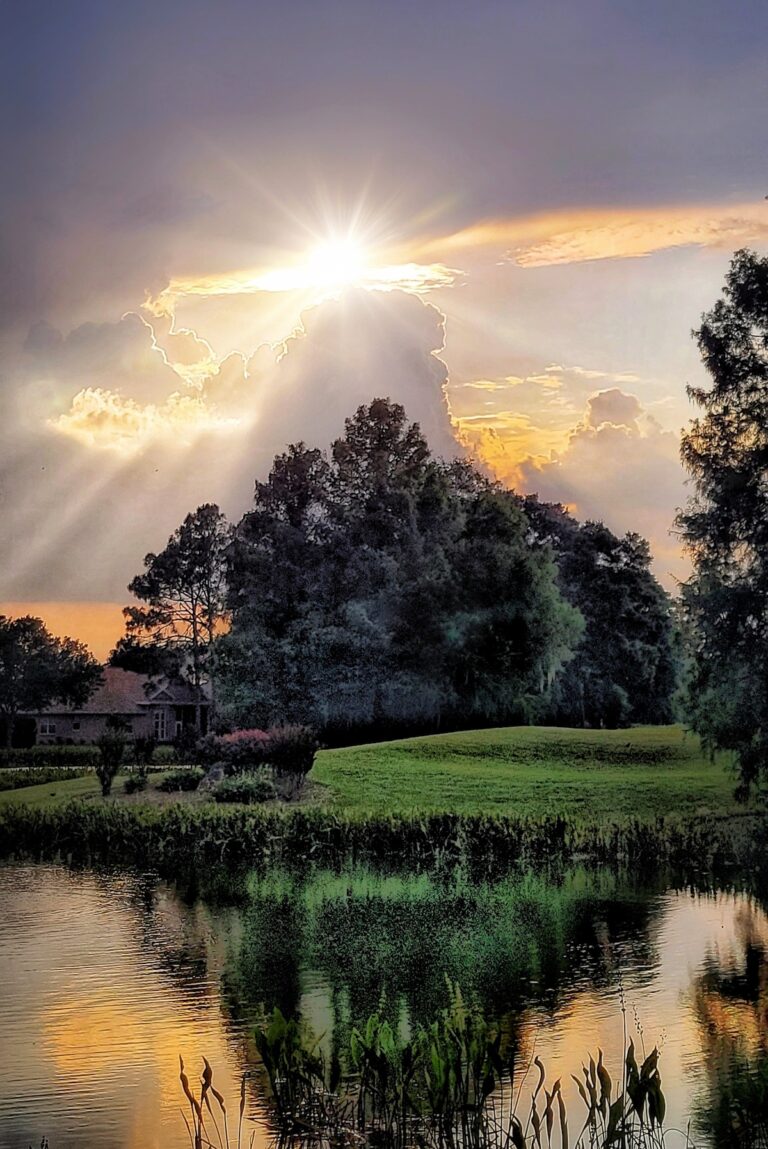 Sun peeking through storm clouds at Oak Run in Ocala